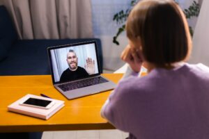 Woman at home face time video call her friends husband boyfriend, chatting online from laptop