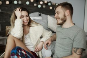 Young couple talking in bedroom