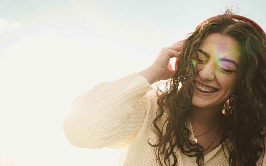 Portrait of a woman with tooth brace listening to the music with headphones